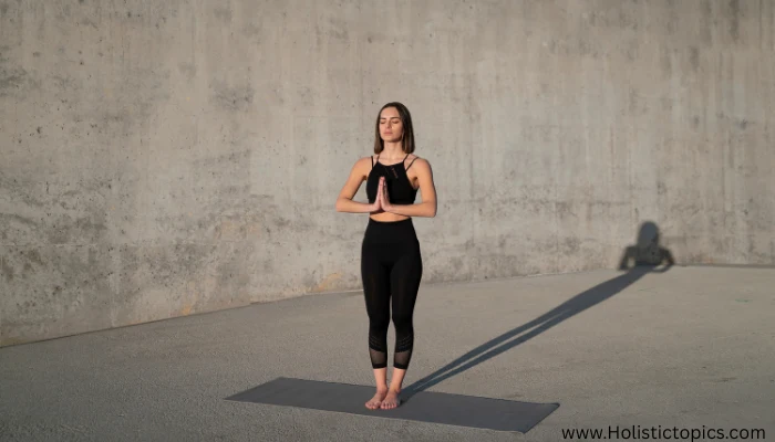 woman practicing Mountain Pose as part of 6 essential yoga poses routine.