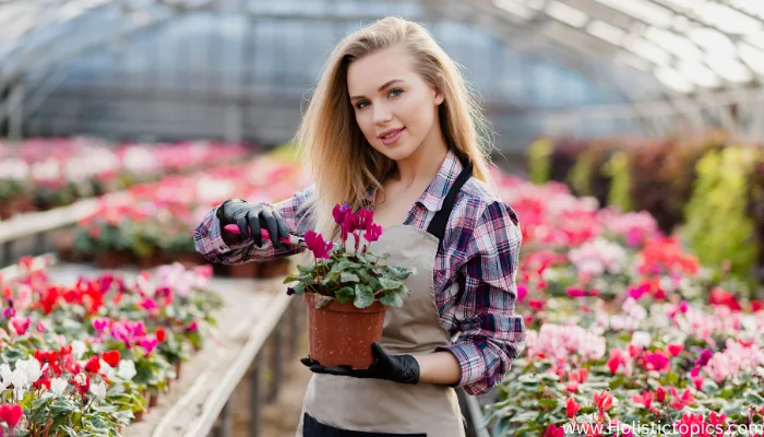 beautiful woman in a greenhouse smiling with glowing skin showing the benefits of plant based diet on skin