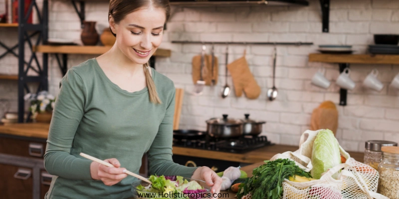 Woman preparing fresh salad in a clean kitchen using healthy kitchen tips.