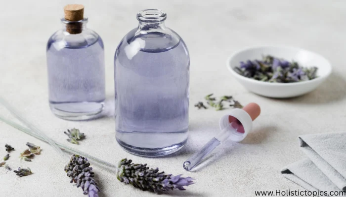 Lavender flowers and lavender essential oil bottles arranged on a soft surface, supporting essential oils for energy cleansing