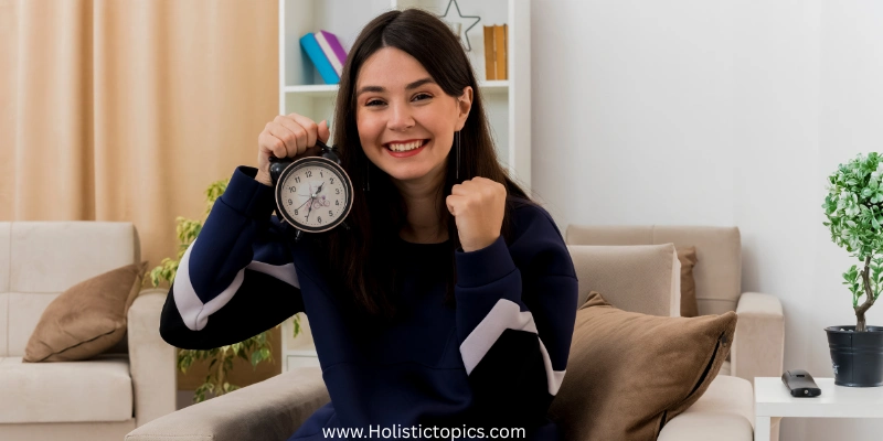 Woman holding a clock and smiling during a midday reset to boost energy and focus.