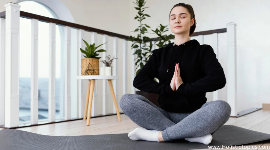 woman practicing yoga for mental health indoors while meditating in a peaceful home environment.