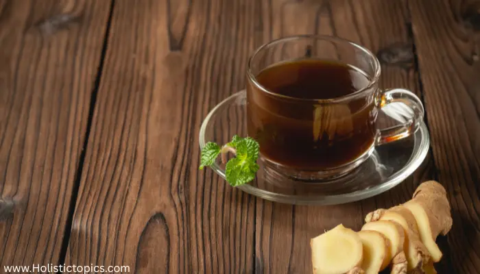 ginger tea Southeast
asia in a glass cup with fresh ginger slices on wooden table for digestion and wellness