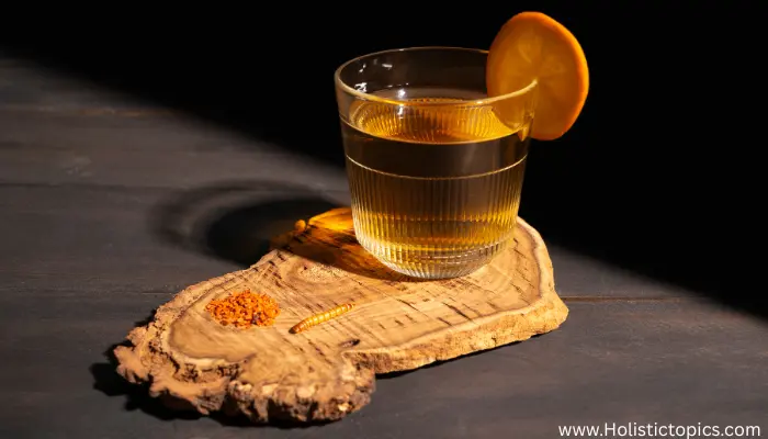 ginseng tea in a clear glass with orange slice served on wooden board for energy and wellness