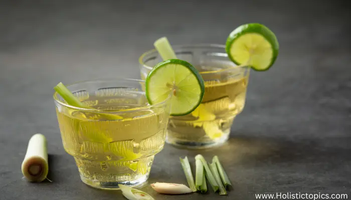lemongrass tea thailand in glass cups with lime slices and fresh lemongrass on table